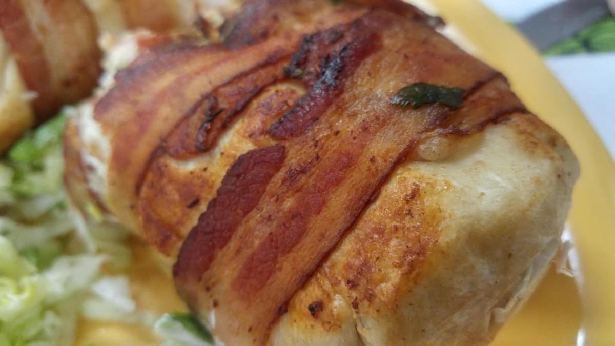 Crunchy-edged bacon was tightly wound around the burrito before grilling.