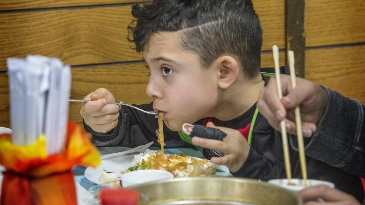 Javier Agee-Coober, 7 of Tacoma had to use a fork to eat his sukiyaki noodles at the Tacoma Buddhist Temple’s 2017 Sukiyaki Dinner after closing his finger in his grandmother’s car door.