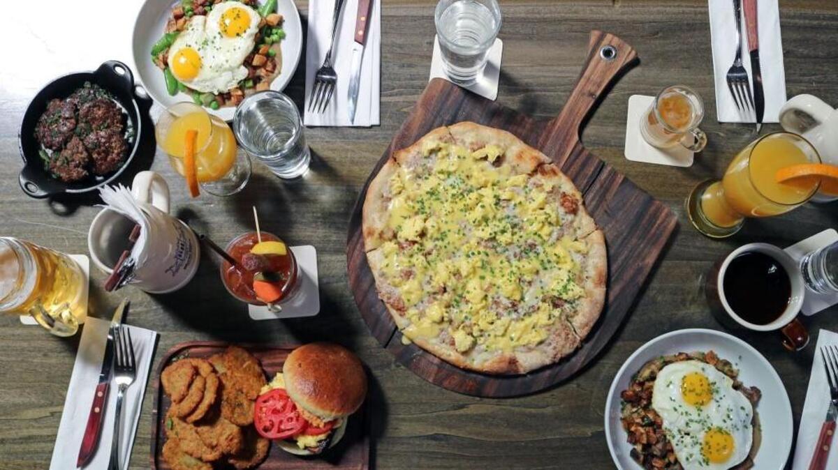 Find an assortment of brunch items, including a schnitzel plate and pancakes, at Rhein Haus in Tacoma.