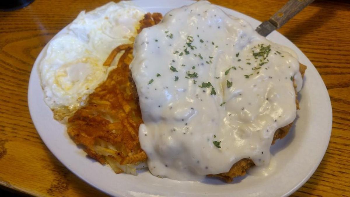 A classic breakfast chicken fried steak with hash browns at Homestead Restaurant and Bakery.