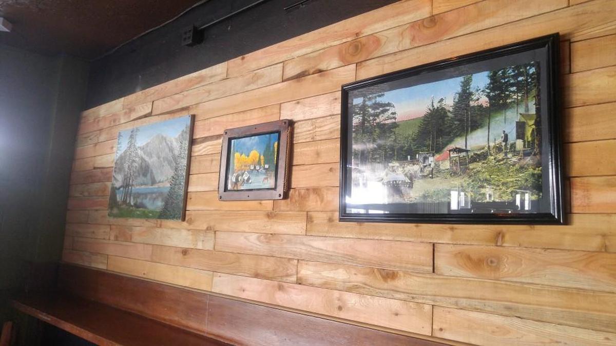 The lodge and camping theme plays out in the “terrible” art Patrick Haight has collected for his The Camp Bar.