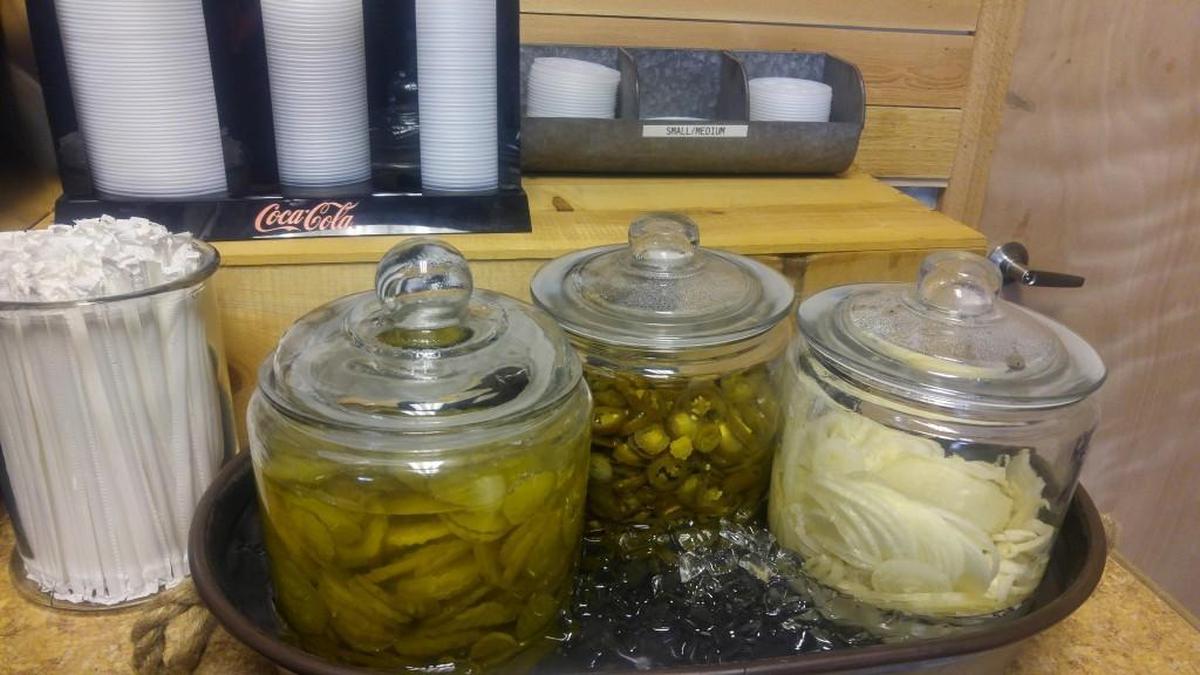 Serve-yourself jalapenos, dill pickle chips and sliced onions at BBQ2U in Gig Harbor.