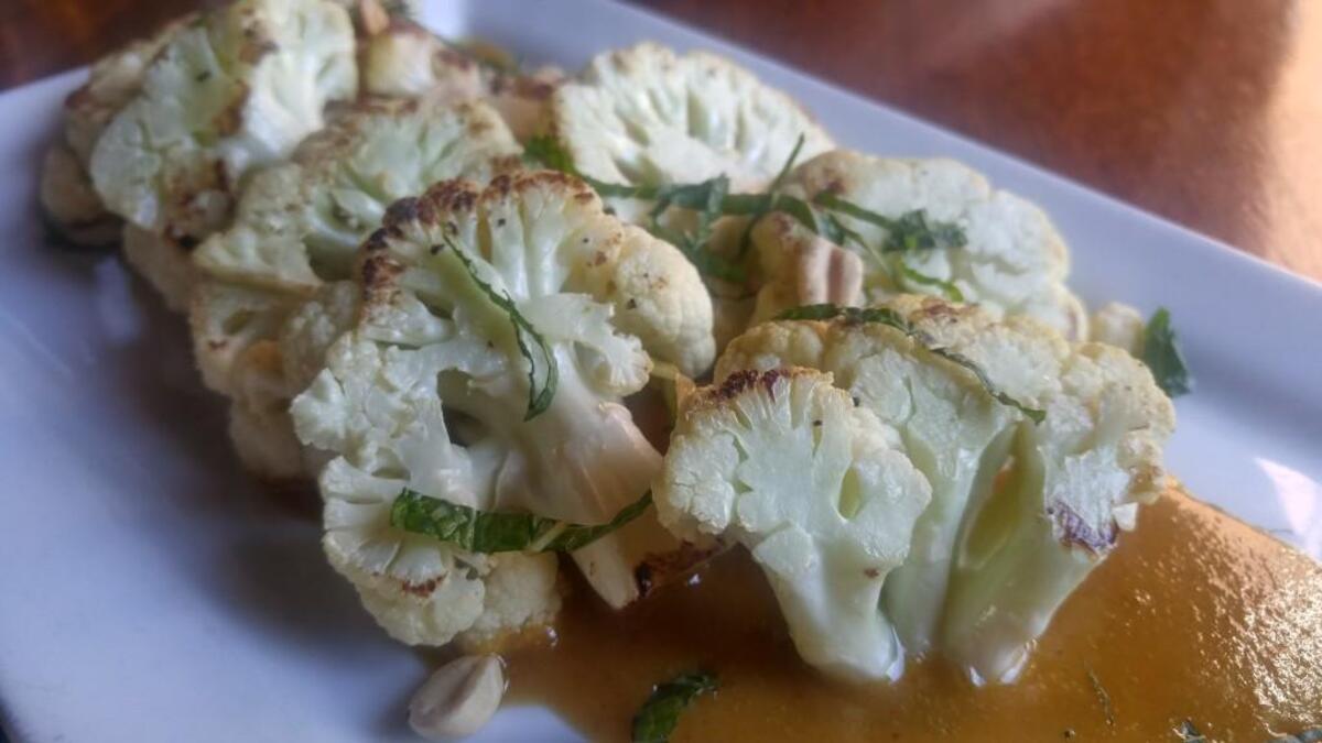 Seared cauliflower at Dirty Oscar’s Annex is served with a curry-tinged peanut sauce.