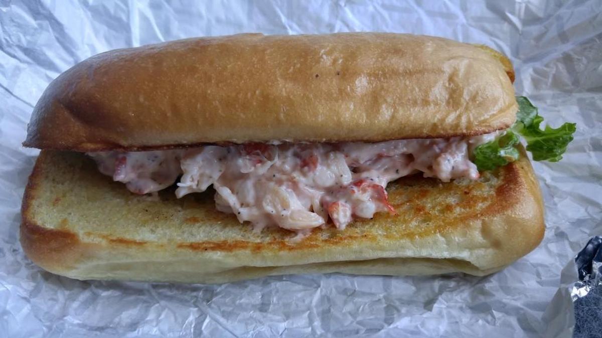 A lobster roll from Wicked Good Eats comes with chilled lobster meat and a simple creamy dressing on a buttered, toasted bun. The one pictured here is not the typical bun used on the sandwiches. They were out.