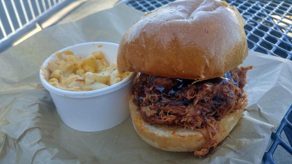 A pulled pork sandwich with macaroni and cheese at the BaRBQ stand at Cheney Stadium during the 2017 Rainiers season. The stand has moved to the main entry behind home plate for the 2019 season and will offer some additional menu items this season.