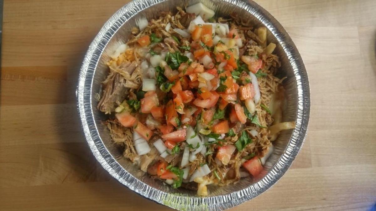 Chronic fries at Lakewood’s Chronic Tacos are loaded with cheese, a choice of meat, rice, beans and as many fresh vegetable toppings and salsas as you ask for.