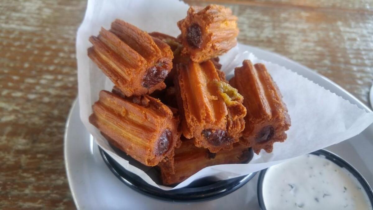 The churros at RoastHouse are cut into bite-size pieces and served with a tequila crema sauce.