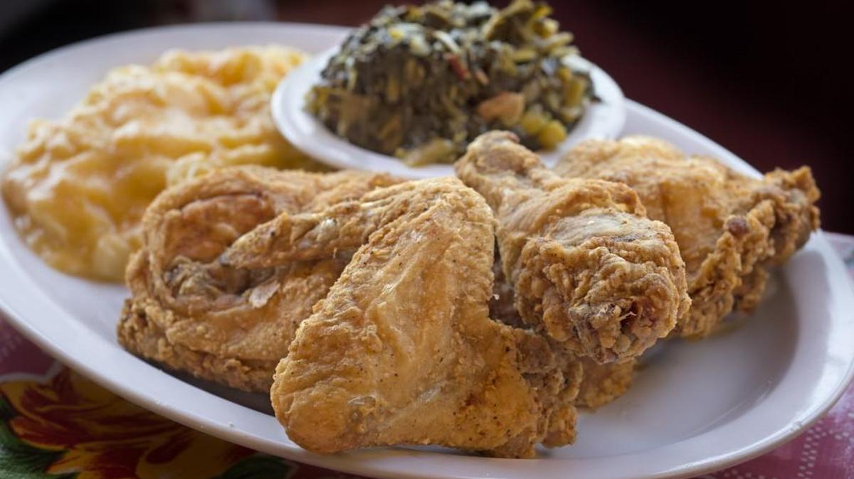 Fried chicken with collard greens and mac and cheese at Southern Kitchen on Friday, Apr. 22.