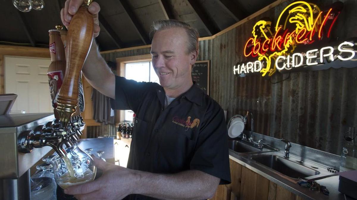Owner Rich Cockrell pours cider at Cockrell Hard Ciders' tasting room in Puyallup on Saturday, Jan. 9, 2015.