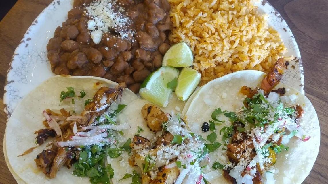 A trio of tacos with beans and rice at Brewers Row.