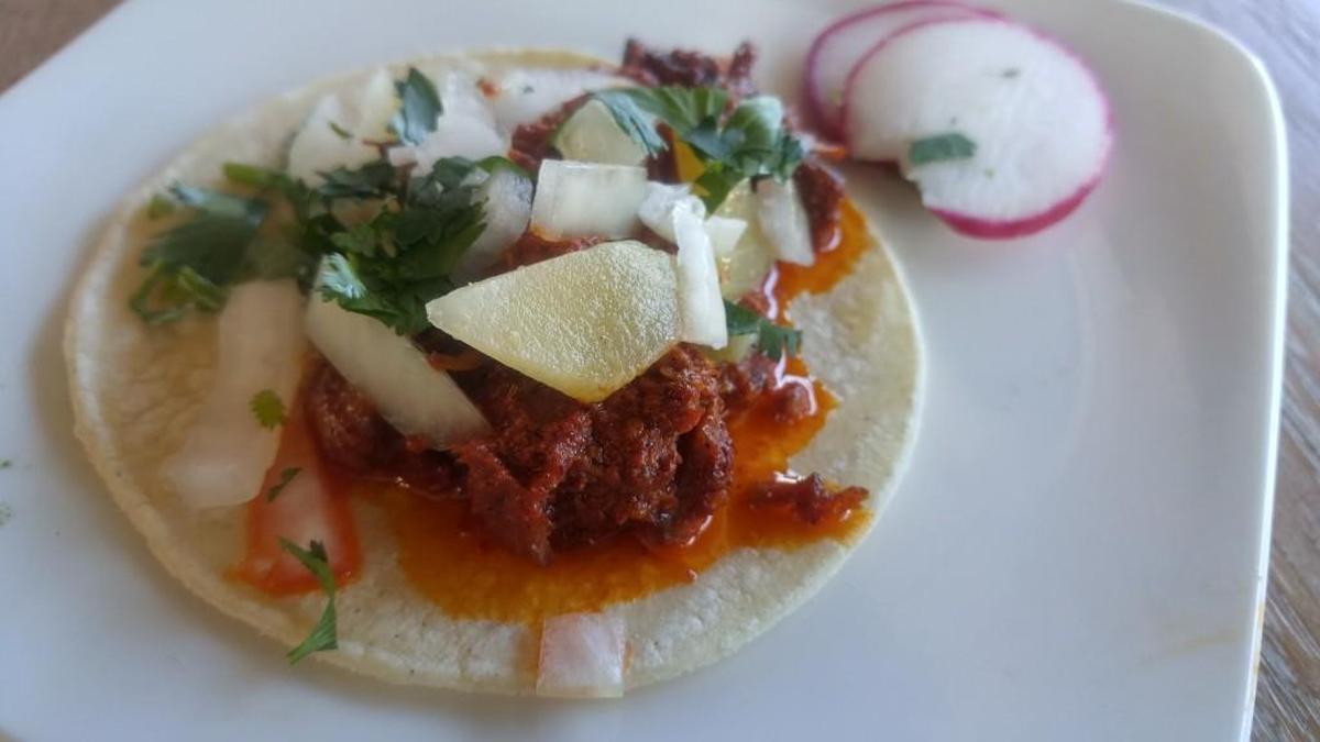 El Borracho’s al pastor tacos at happy hour are topped with fresh pineapple.