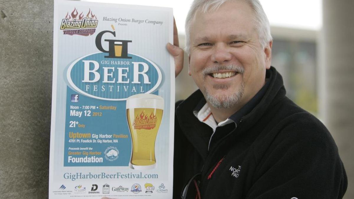 
John Fosberg is pictured here with a poster from the Gig Harbor Beer Festival, an event he has organized since 2012. Fosberg just opened his Gig Harbor Brewing Co. in Tacoma’s Nalley Valley neighborhood. 
