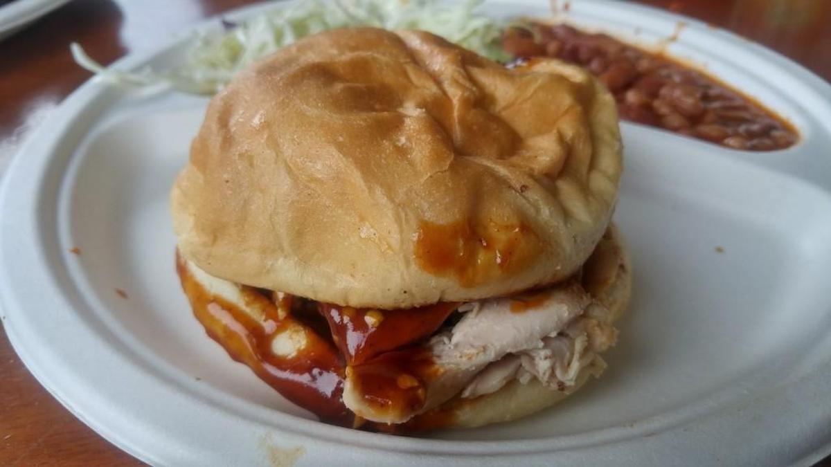 A pulled-chicken sandwich with sauce from Rib Ticklers Barbeque.