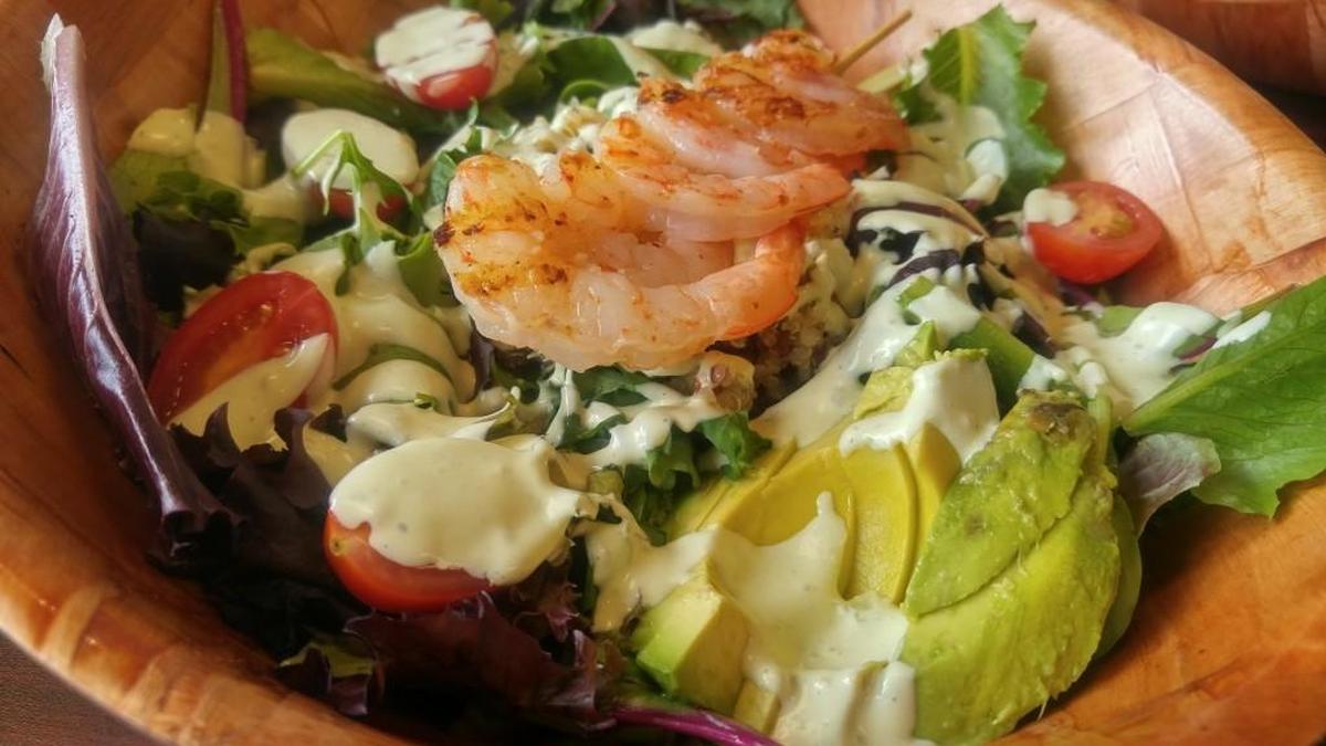 The shrimp Aztec salad comes with quinoa salad and half an avocado sliced on top at The Garden Bar, which just opened in Tacoma’s East Side neighborhood.