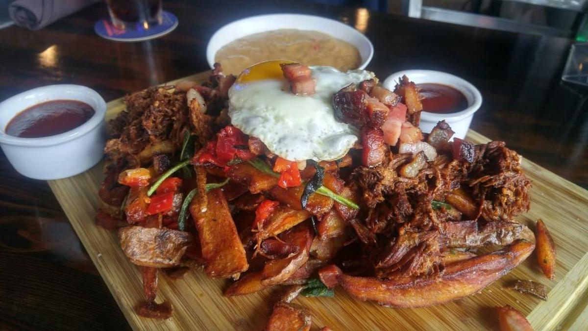 The fries are piled high on a wood platter at The Mill.