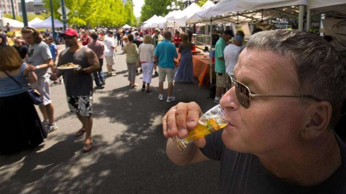 
John Mabbott of Auburn sips a beer from Wingman Brewers during Brew Five Three “Tacoma’s Beer & Blues Festival” held at Broadway between Ninth and 11th streets in Tacoma. 
