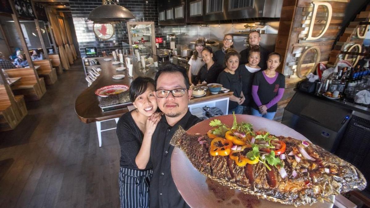 Indo owners Buoy Ngov, left, and Vathunyu Nanakornphanom show off their fried tilapia with tamarind chili sauce Nov. 19 at Indo Asian Street Eatery in Tacoma.