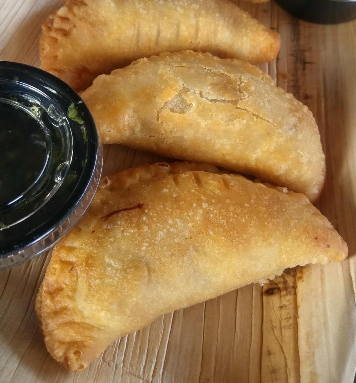 Chimichurri is served on the side with flaky empanadas from Carne Aqui in Parkland.