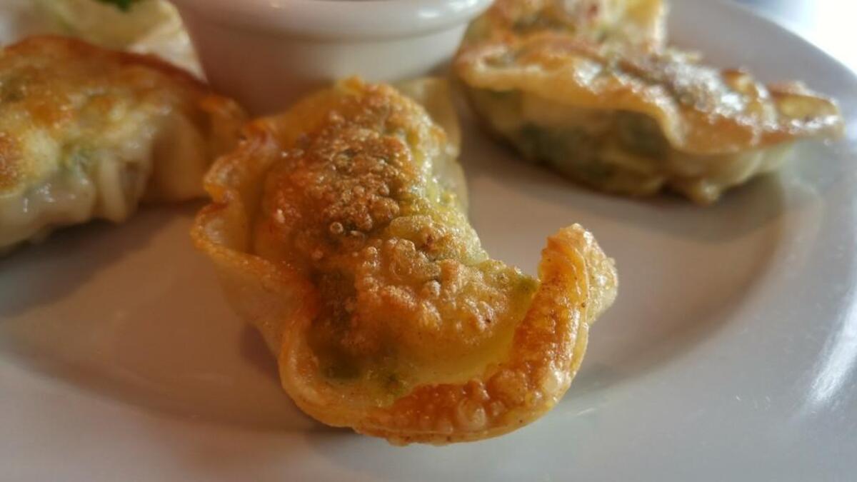 Shrimp and chive dumplings are pan-fried until the edges are crispy.