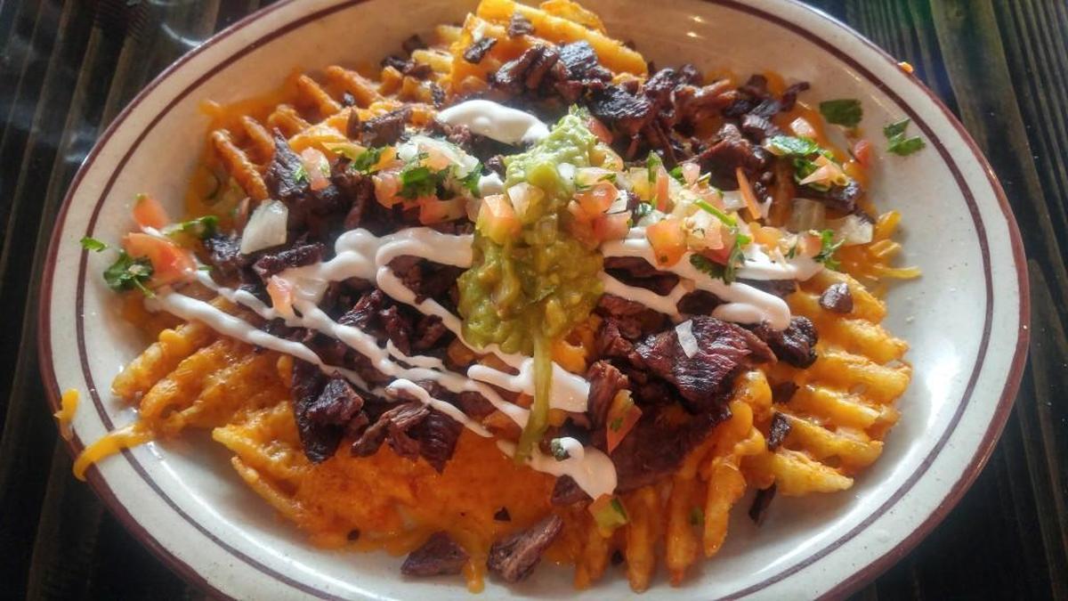 Asada fries at Picazo’s Taco Zone are served with waffle fries and cheddar cheese.