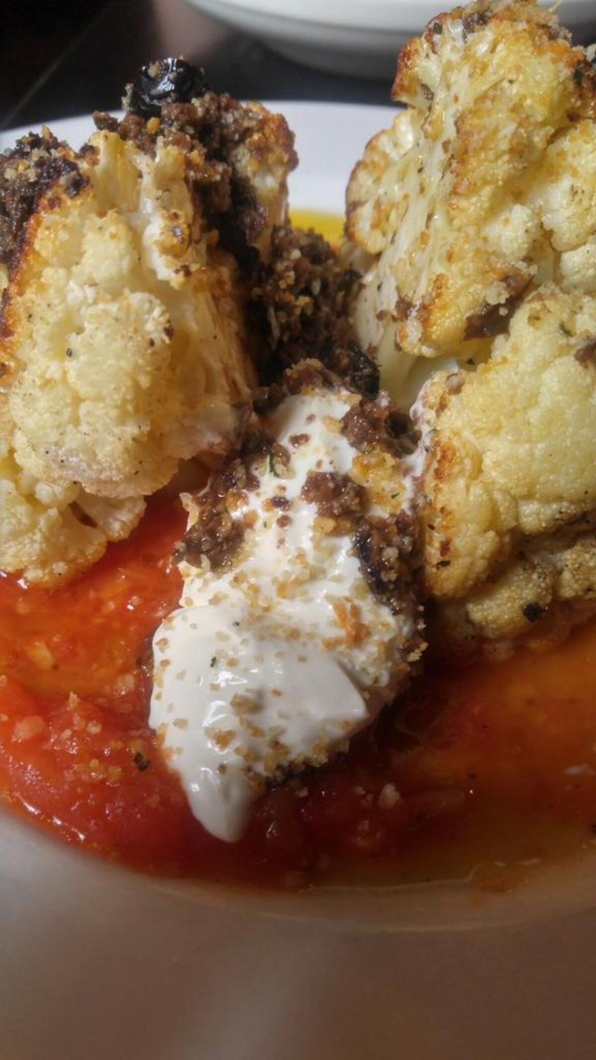 Cauliflower at Pacifc Grill is served as a steak, with whipped goat cheese, an olive tapenade and tomato sauce.