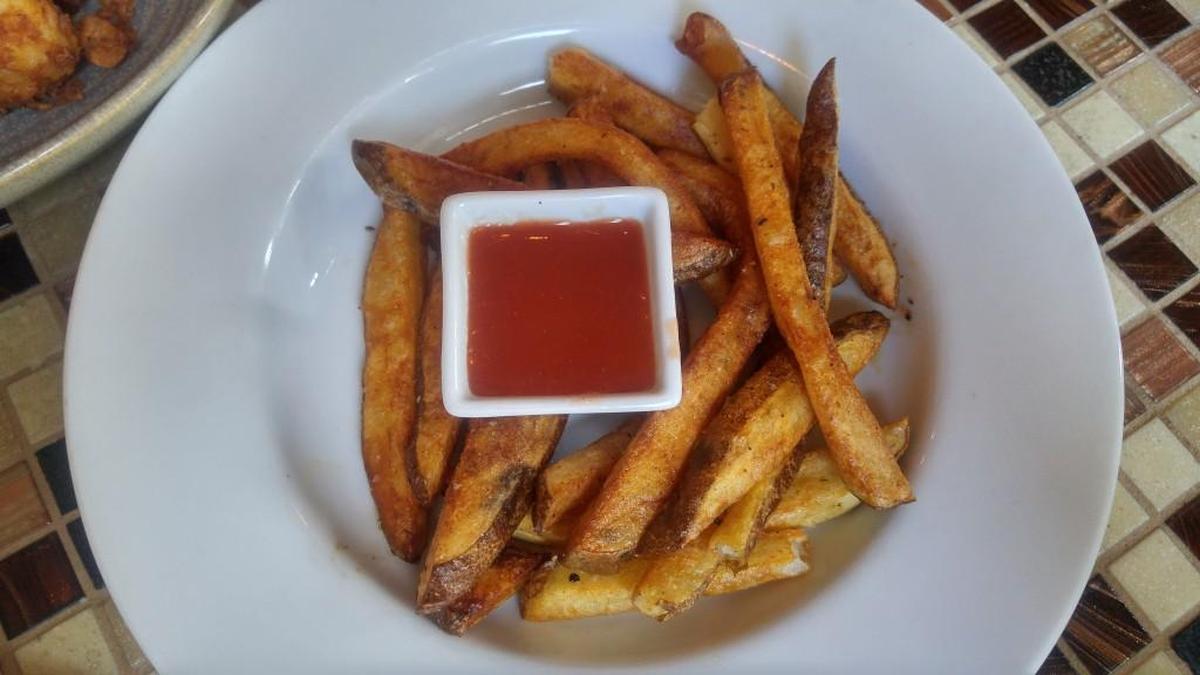An order of hand-cut frites with cola ketchup from Wilder Local Fare + Libations.