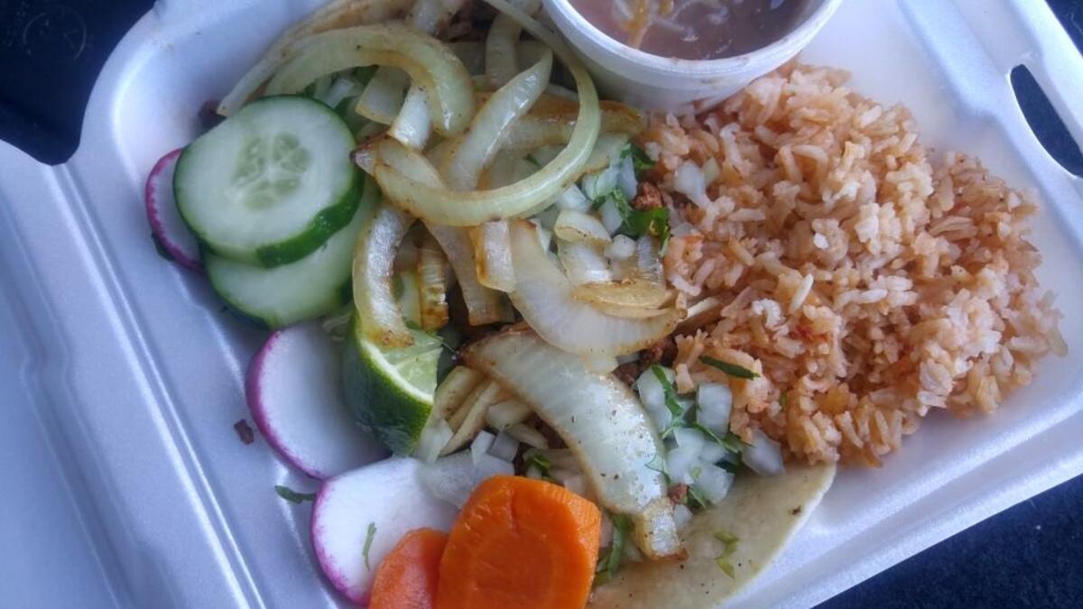 A taco combo plate with rice and beans.