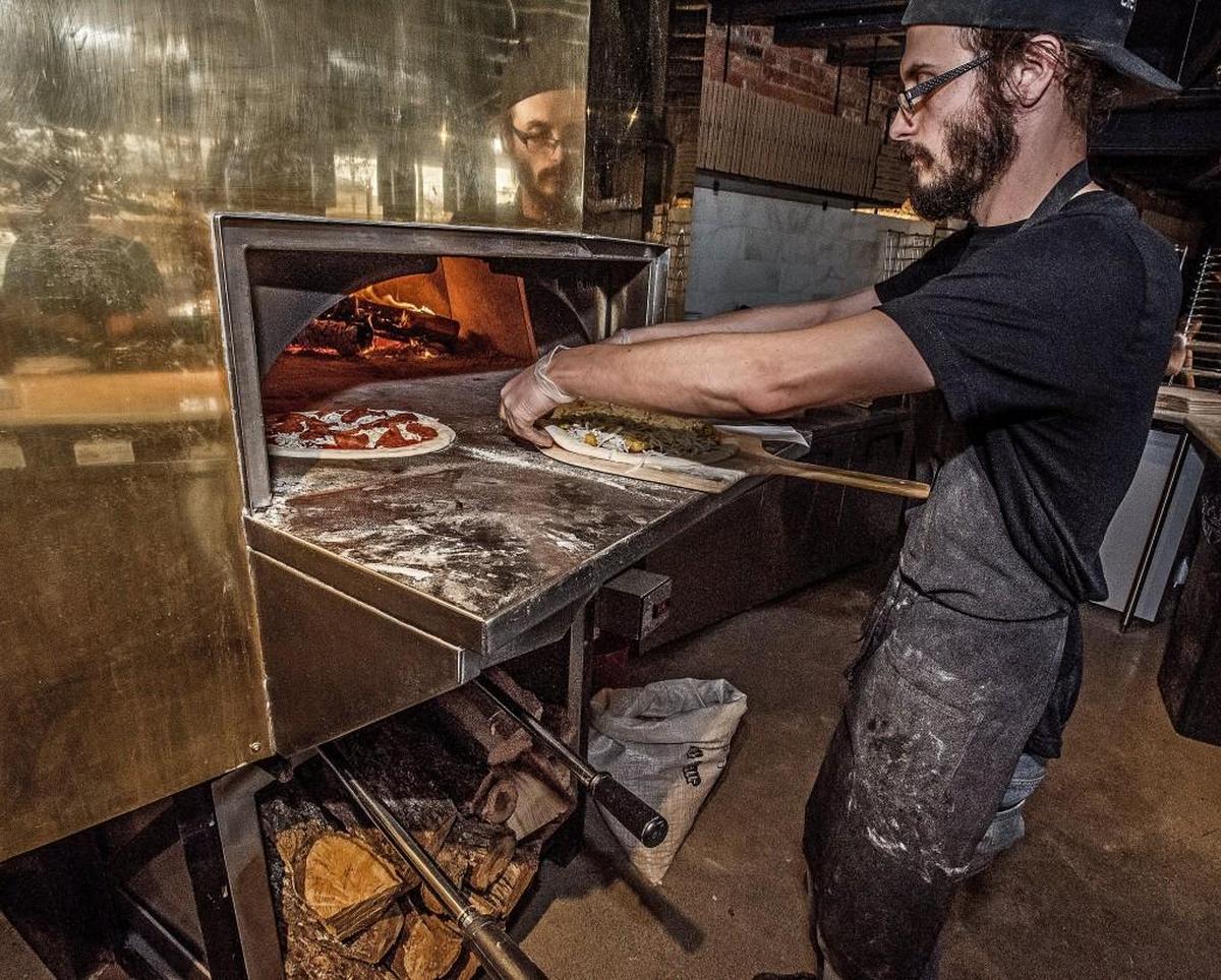 Matt Groggans prepare pies for cooking in the wood-fired oven at Elemental Pizza, 1702 Pacific Avenue Tacoma, Wednesday Oct. 7, 2015.