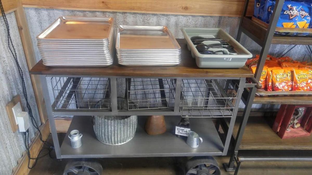 A cart with trays and silverware. Load up on both before you order at the counter.