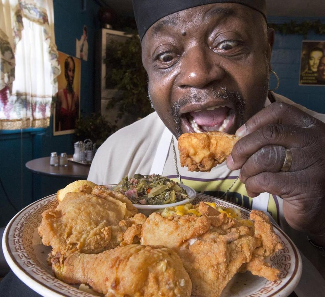 Uncle Thurms’ Thurmond Brokenbrough readies to chomp down on his southern fried chicken at the G Street restaurant in Tacoma.