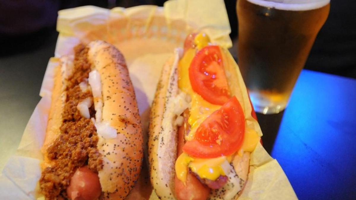 Pictured here are a Coney Dog, left, and a Hilltop Strangler from The Red Hot in Tacoma. The Sixth Avenue restaurant and tavern will bring back its hot dog stand this year to Cheney Stadium for the Rainiers season, which opens Thursday.