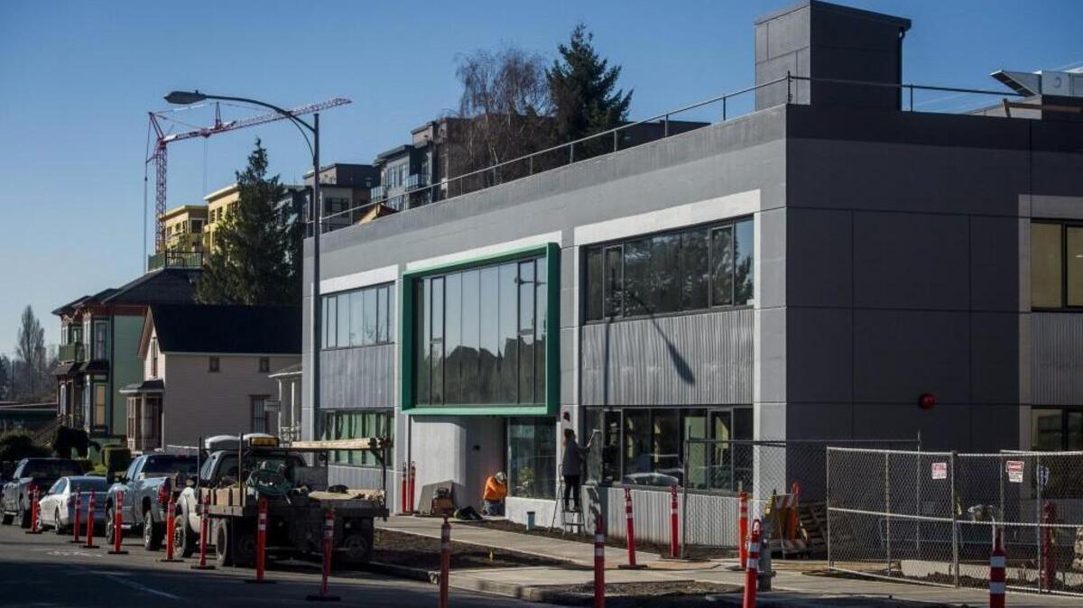 Construction crews work on the old Carpenter’s Union building, which is home to an arts organization called Alma Mater that will host two restaurants. The first of the restaurants to open will be Honey.