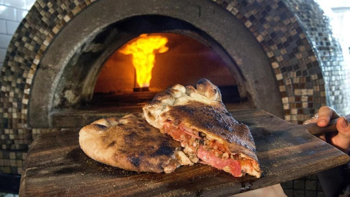 The Brute calzone at Paesan's Kitchen & Bar is baked in an artfully-styled brick oven. Their version of the East Coast favorite features a Pomodoro red sauce, mozzarella and fontina cheese, pepperoni, salami and Italian sausage.