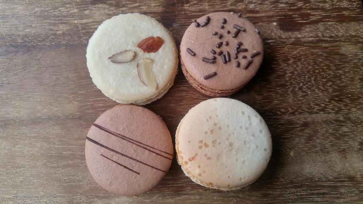 An assortment of macarons from La Waffletz and Macaron Station. Pictured here, from top left clockwise, is an almond, Nutella, salted caramel and double chocolate macaron.