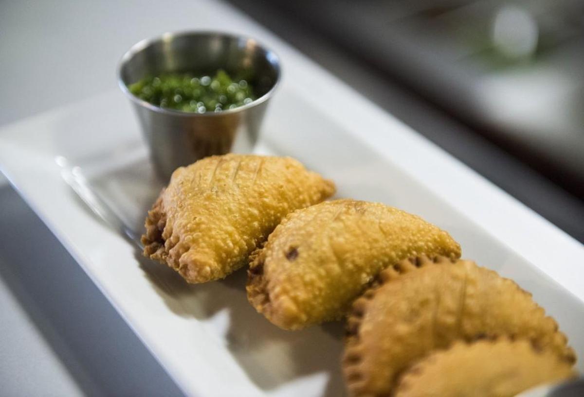 Empanadas filled with braised lamb shank, pork shoulder, roasted red peppers and green chiles with house seasoning at Carne Aqui in Parkland.