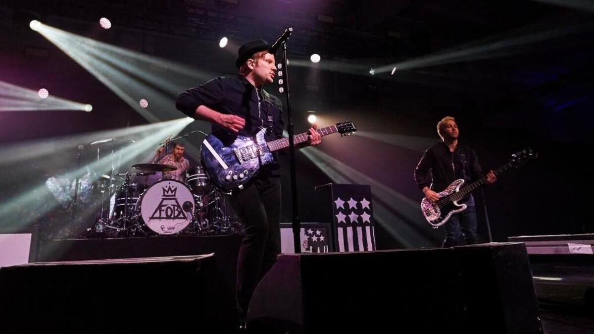 Andy Hurley (drums), Patrick Stump (vocals), and Pete Wentz (bass) of Fall Out Boy performing in 2015.