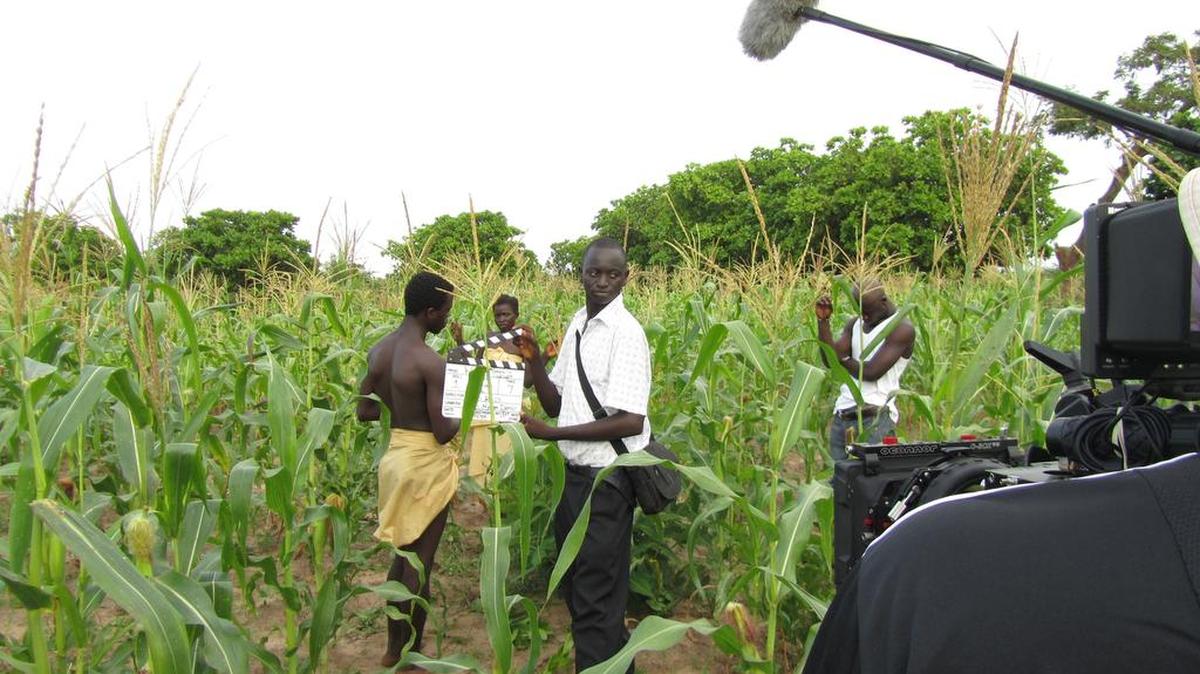 Filming in the Gambian fields for the documentary, “Kunta Kinteh Island: Coming Home Without Shackles.”