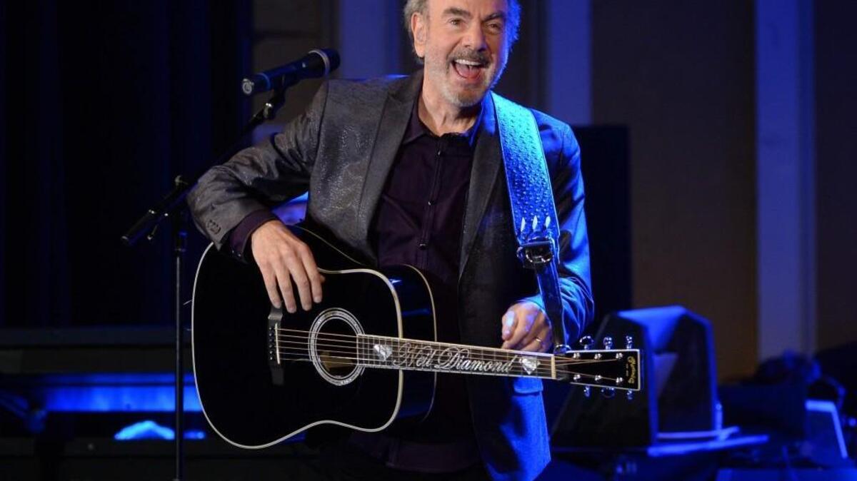 Singer-songwriter Neil Diamond performs at his former high school, Erasmus Hall High School, for his first-ever performance in his hometown in the Brooklyn borough of New York on Monday, Sept. 29, 2014. Diamond was promoting his upcoming release, "Melody Road." (Photo by Evan Agostini/Invision/AP)