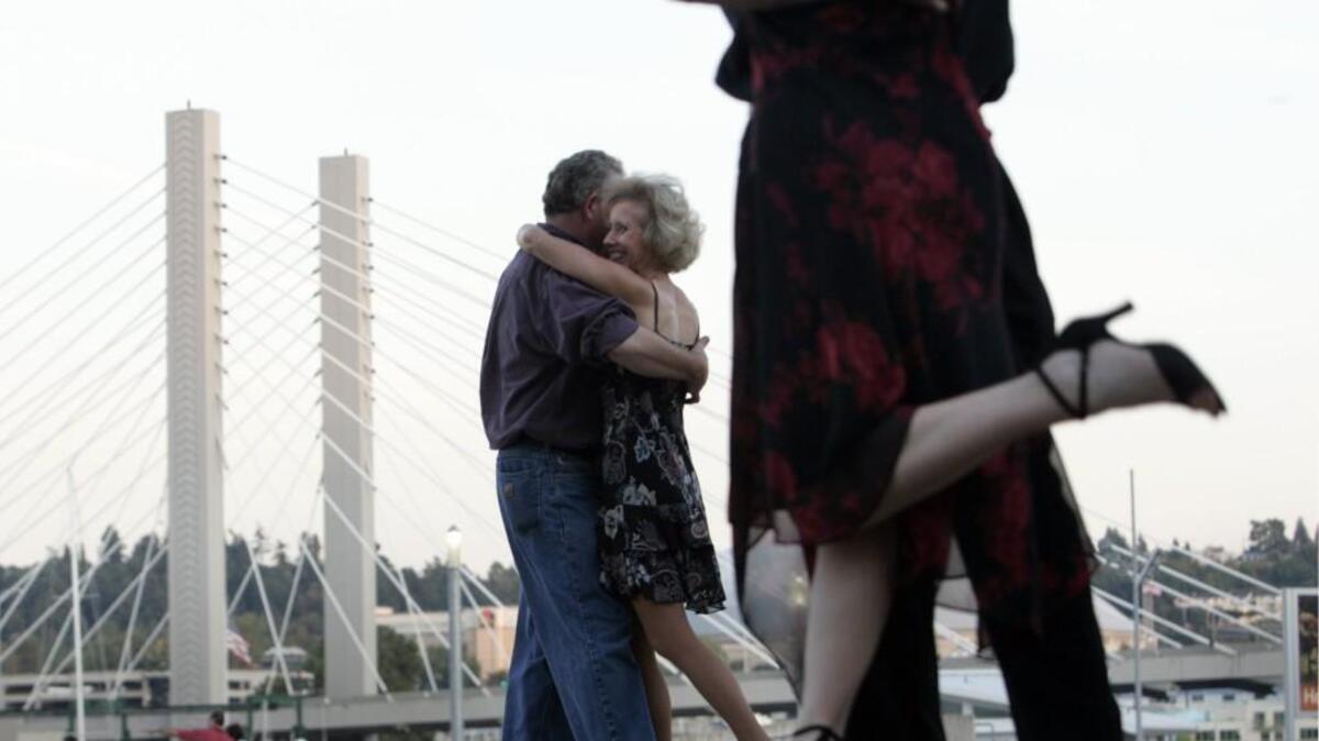 David and Elizabeth Walsh, foreground, and Ken Brown and Karen Ideker, background from left, dance the Argentine Tango on an outdoor plaza at the Museum of Glass in Tacoma in 2008.