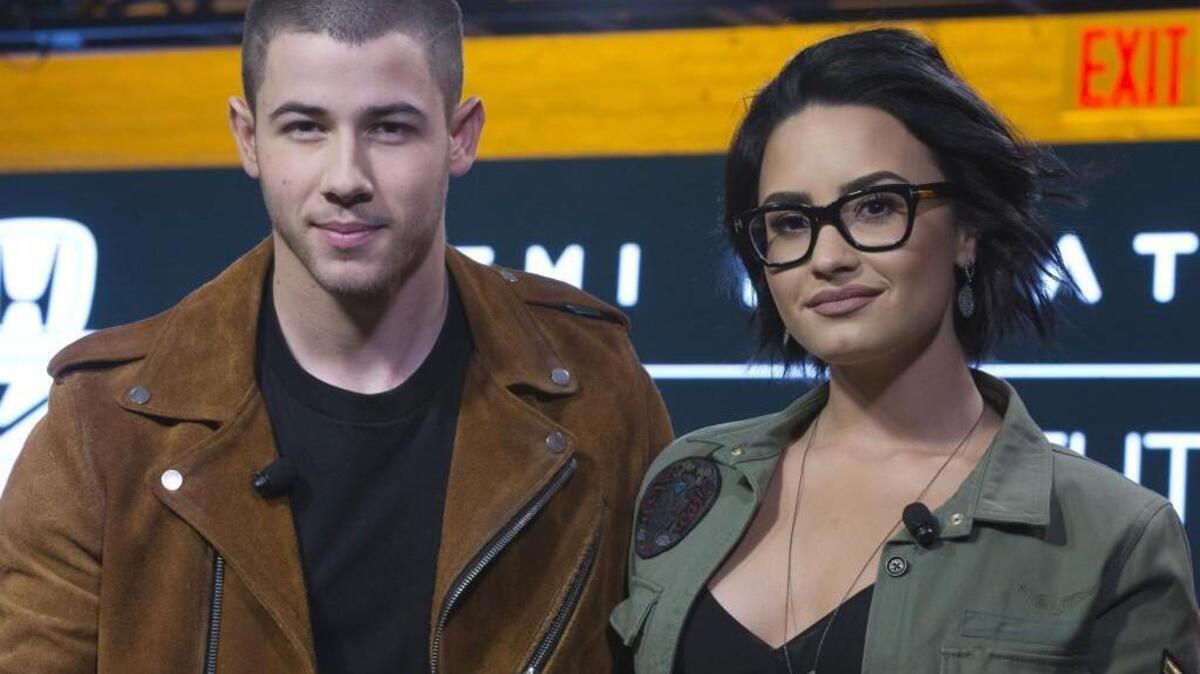 Demi Lovato, right, and Nick Jonas appear onstage during a Honda-sponsored news conference, Tuesday, March 22, 2016, in New York.