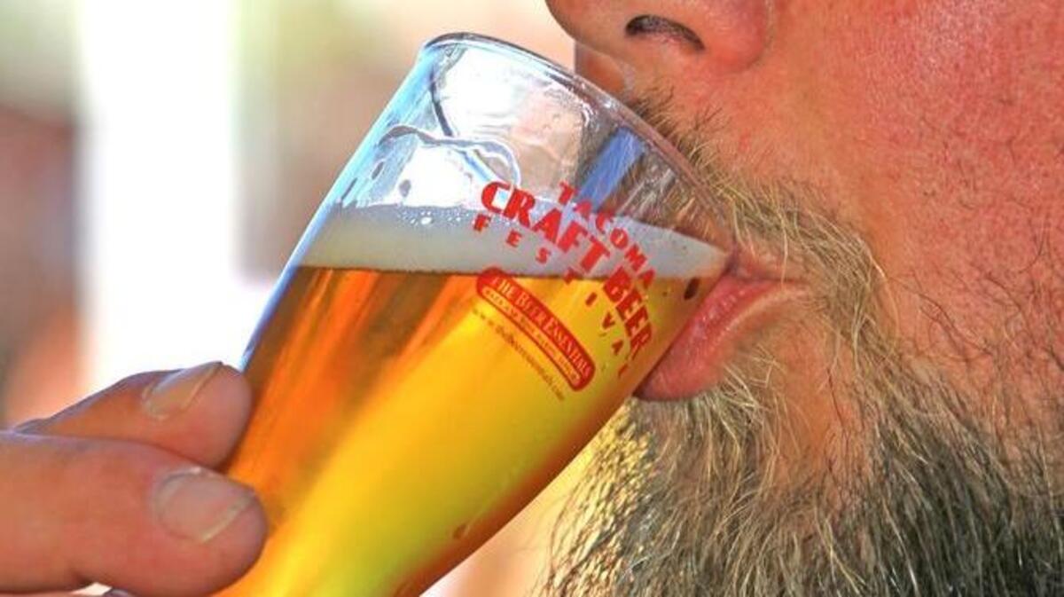 Joel Young of Tacoma samples a 777 Scuttlebutt Belgian Trippel ale during the Tacoma Craft Beer Festival in 2011.