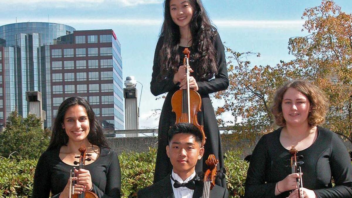 From left, Bianca Ponnekanti, Casey Kim (in back), Andrew Tu and Kathryn Tschida are members of the Tacoma Youth Symphony, which will perform Sunday at the Rialto Theater.