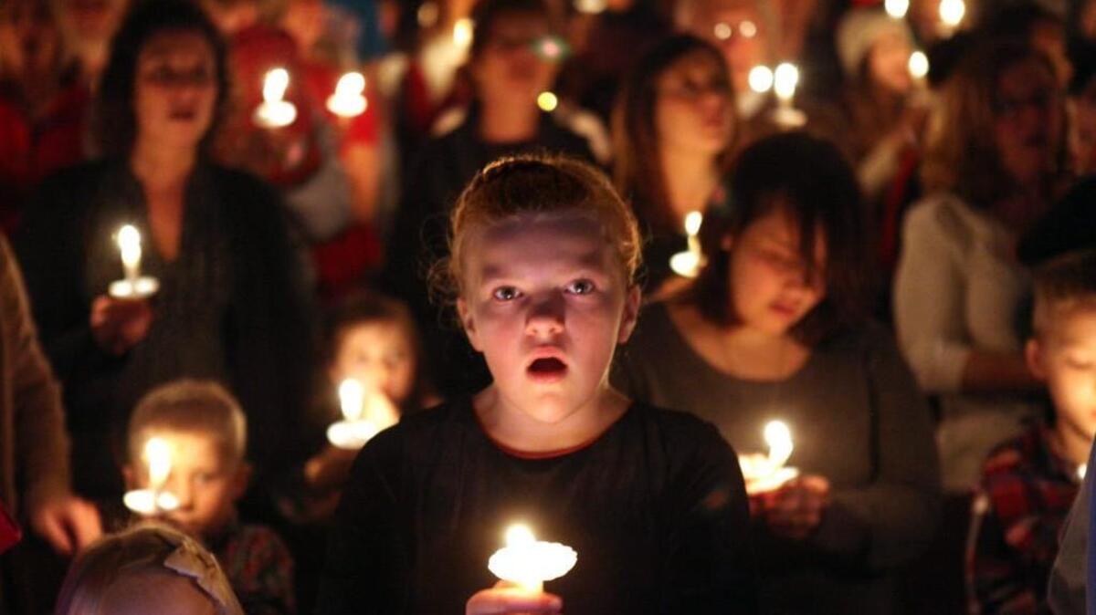 Macy Bergford, 10, of Olympia, sings “Silent Night” along with members of the Church of Living Water at Christmas Eve services in 2010.