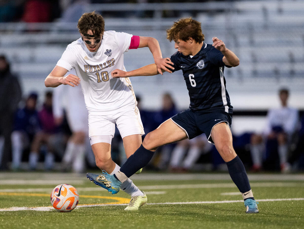 Puyallup midfielder Roby Hooper (10) avoids the steal attempt from Bellarmine Prep midfielder Henry Marlow (6) during the match at Bellarmine Preparatory School, on Tuesday, April 16, 2024, in Tacoma, Wash.