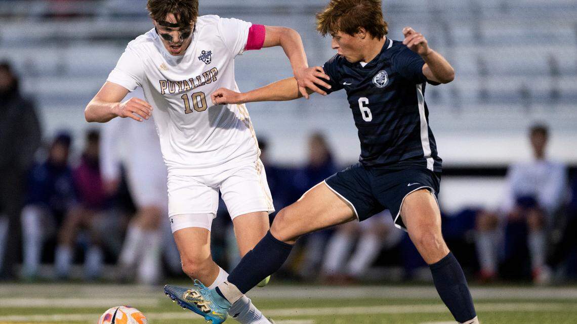 Puyallup midfielder Roby Hooper (10) avoids the steal attempt from Bellarmine Prep midfielder Henry Marlow (6) during the match at Bellarmine Preparatory School, on Tuesday, April 16, 2024, in Tacoma, Wash.