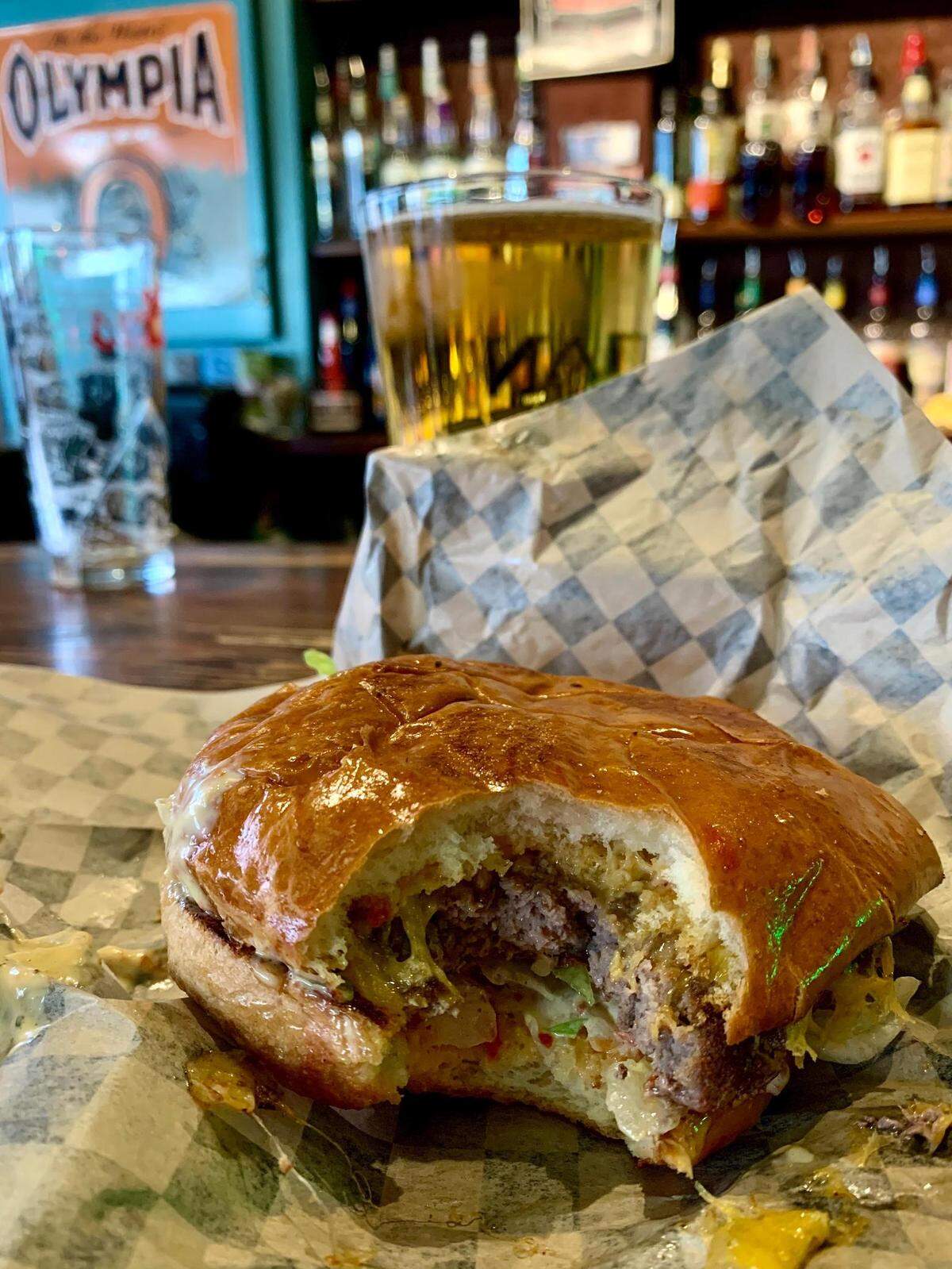 The Valley, one of the Peterson Bros. bars in Tacoma, Wash., serves great subs and a classic American burger, pictured here with a Rainier.