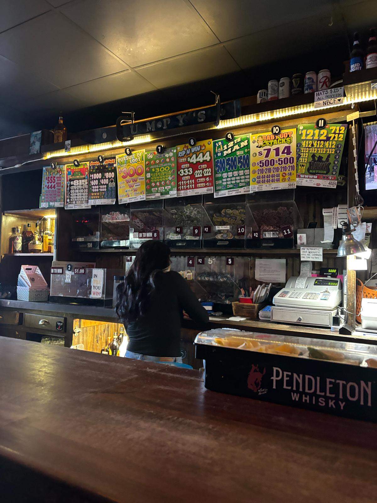 Brooklyn Smith, the new owner of beloved Puyallup bar Bumpy’s Pub at 116 E. Main Ave., works behind the counter on Oct. 13, 2025.