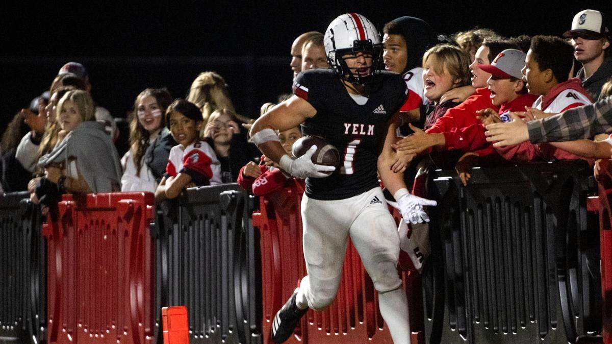 Yelm’s Ray Wright celebrates with the fans after scoring a touchdown in the third quarter of a 3A SSC game against Timberline on Thursday, Oct. 13, 2022, at Yelm High School in Yelm, Wash.
