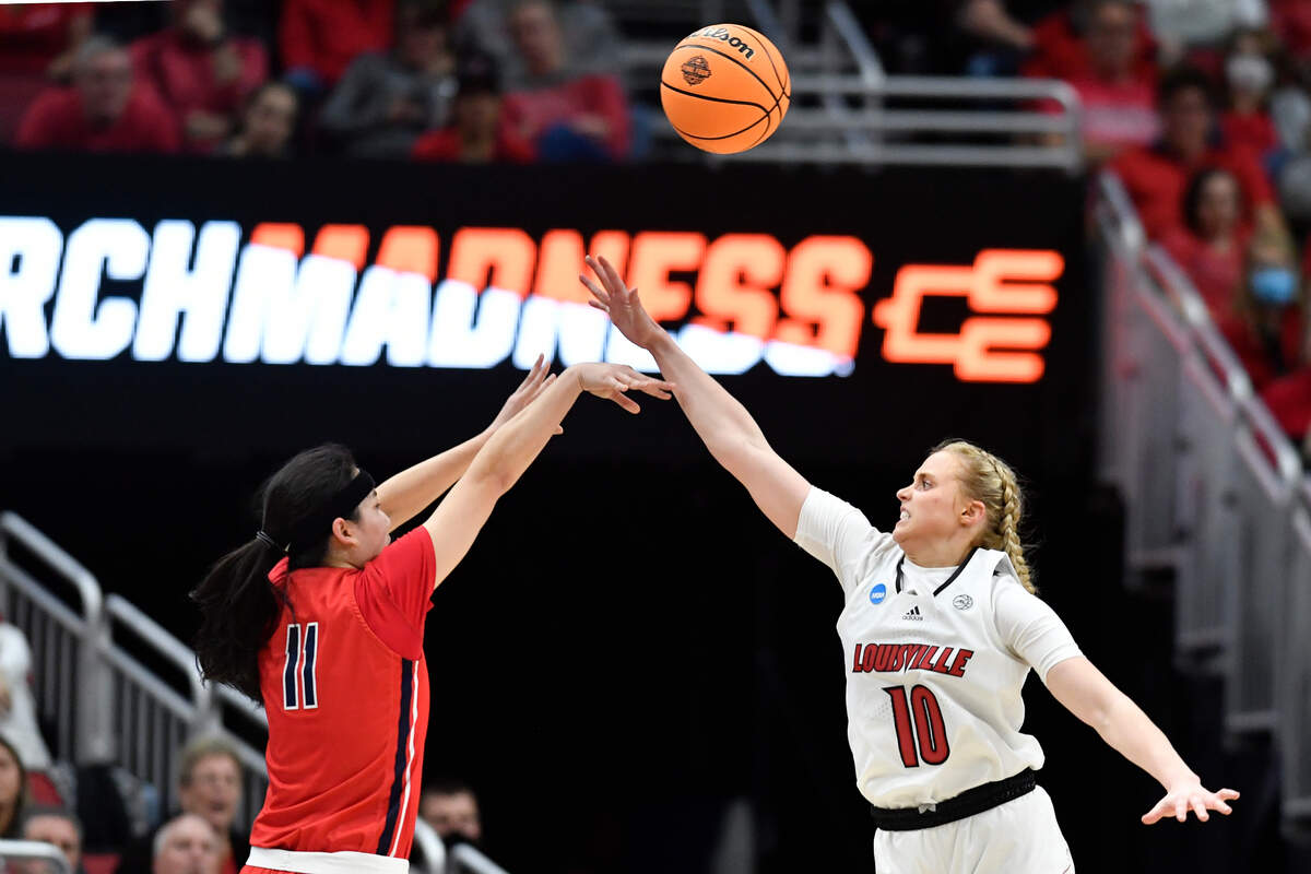 Louisville guard Hailey Van Lith (10) attempts to block the shot of Gonzaga guard Kayleigh Truong (11) during the second half of a women’s NCAA tournament college basketball second-round game in Louisville, Ky., Sunday, March 20, 2022. Louisville won 68-59. (AP Photo/Timothy D. Easley)