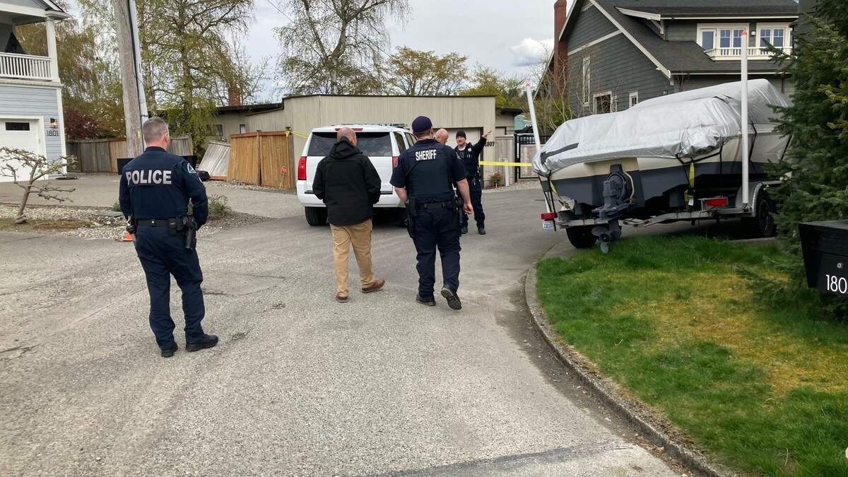 Investigators on the scene of a possible homicide on Day Island near University Place, where a body was found in a car Monday, April 11, 2022.
